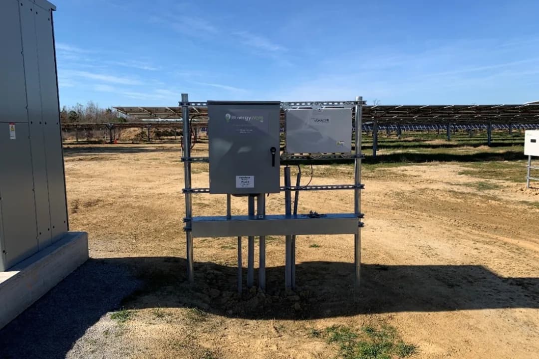 Outdoor equipment rack with monitoring and communications enclosures at a solar site, supporting the solar data acquisition system (DAS).