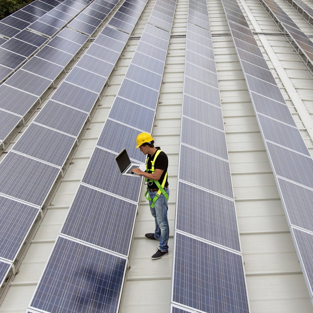 Gathering Solar Data Image of an engineer gathering data in a photovoltaic farm on a roof top (ISO 200). All my images have been processed in 16 Bits and transfer down to 8 before uploading.